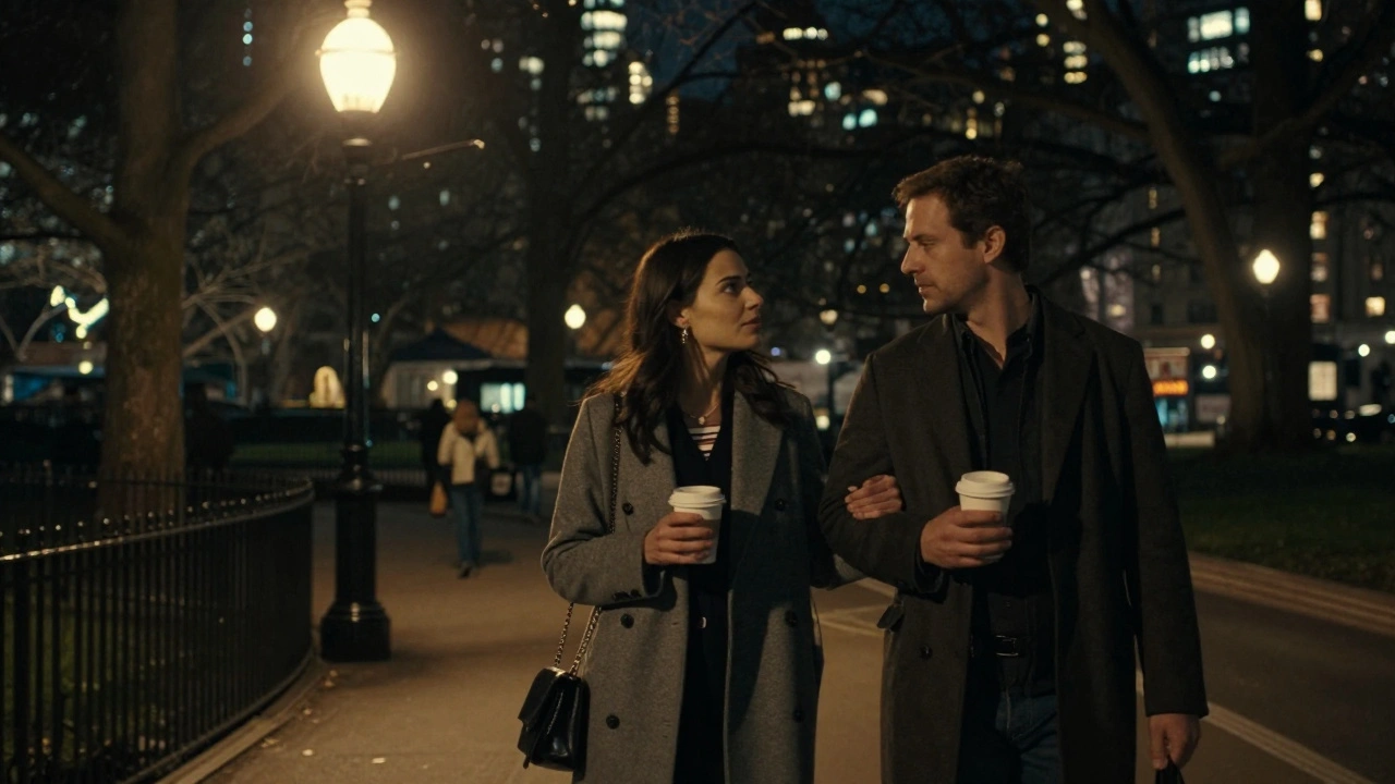 A couple walks peacefully through Hyde Park at night, sharing quiet conversation under streetlamps.