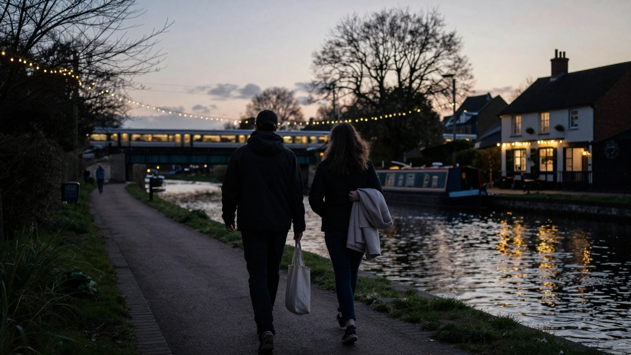 Two people walking peacefully along the Grand Union Canal at dusk in Hounslow.