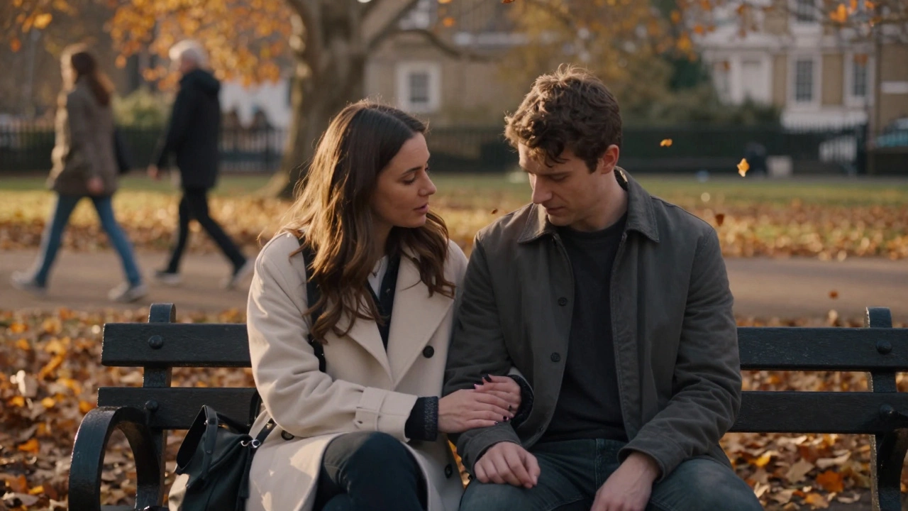 Two people sit on a park bench at dusk, sharing a silent, comforting connection amidst falling autumn leaves.