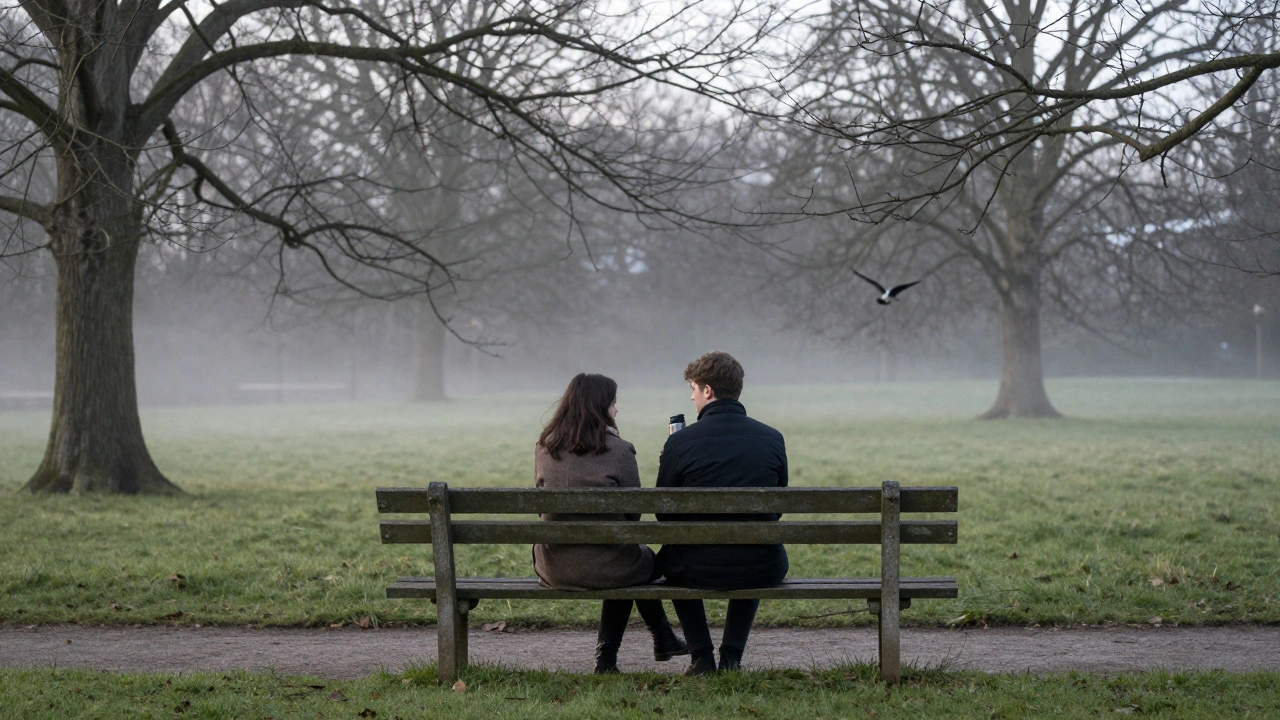 A couple shares a quiet moment on a bench in Green Park at dawn, mist rising around them.