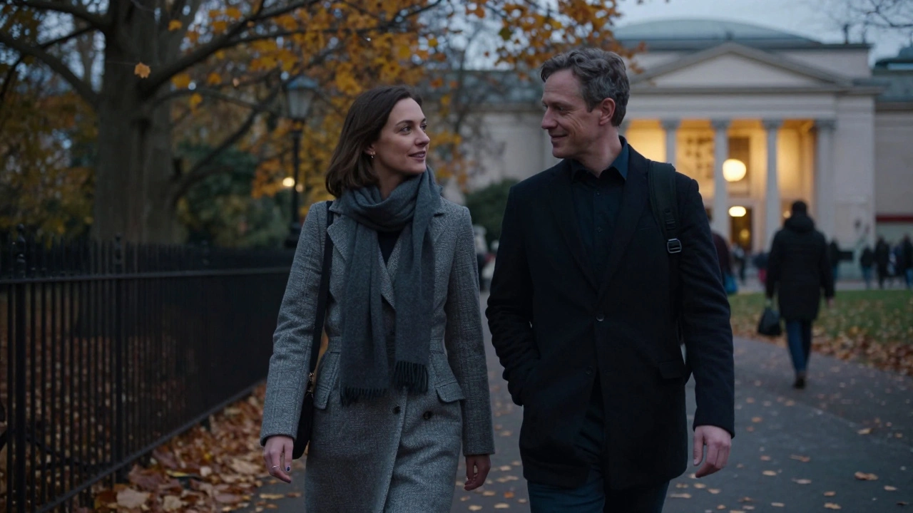 A man and woman walking peacefully through autumn leaves in Hyde Park, lost in calm conversation.