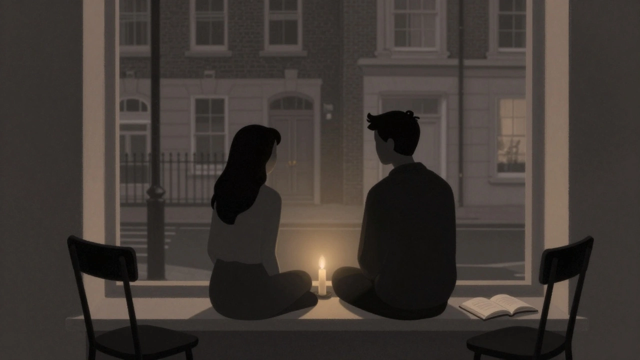 Two silhouettes sit side by side by a window at night, a candle between them, symbolizing presence without words.
